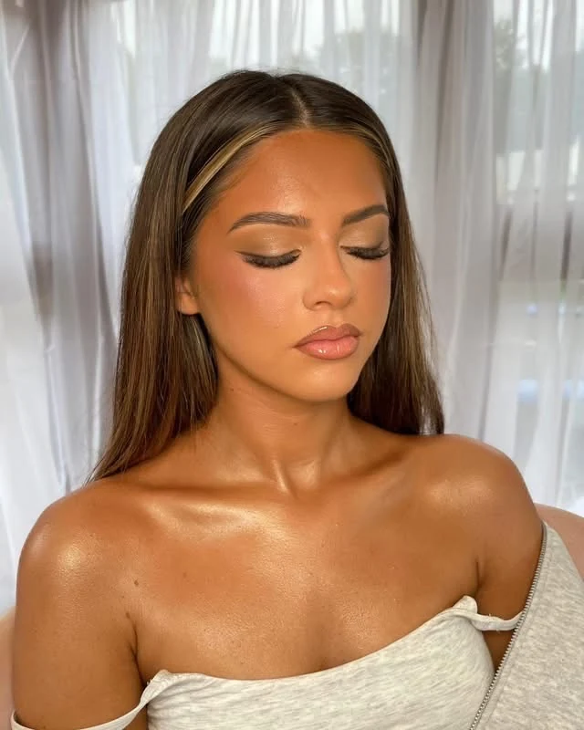 Warm smoky eyes and a nude lip on a brunette client