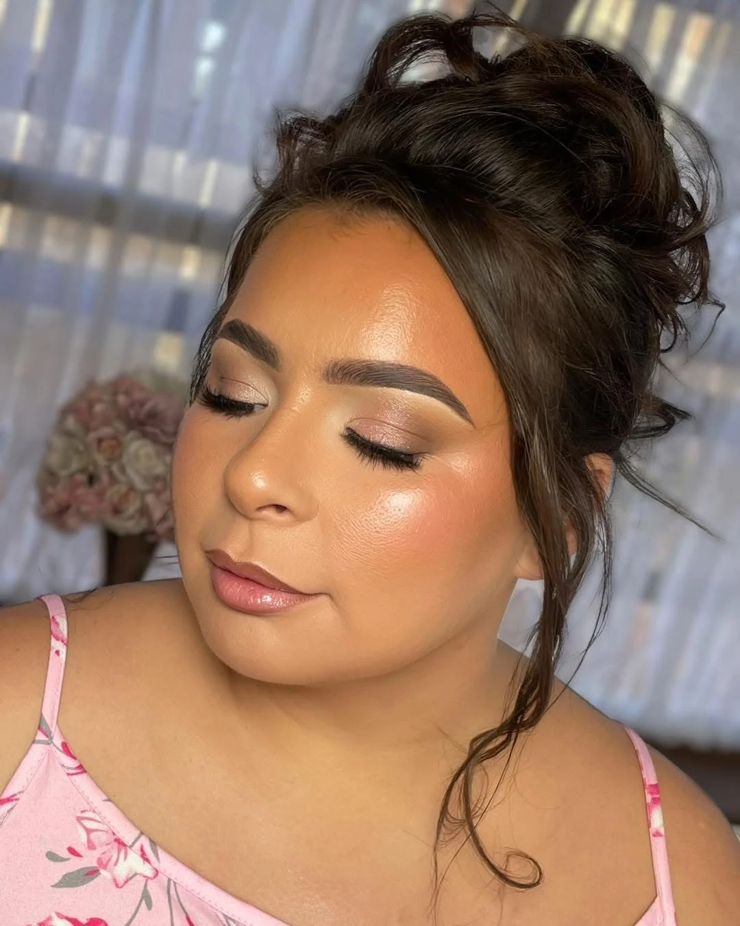 Golden eye makeup and a luminous complexion on a client with dark hair