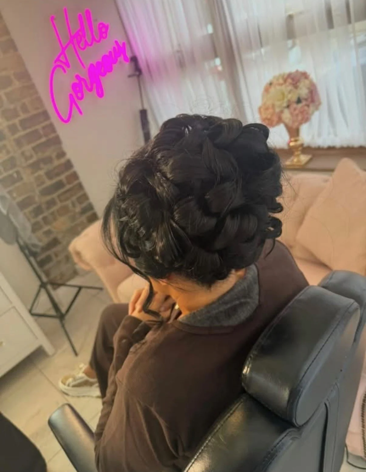 A rear view of a dark pin-up with intricate large curls